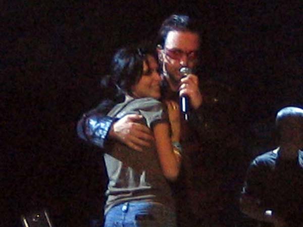 Bono with girl on stage